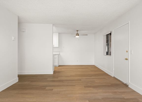 A room with wooden floors and white walls.