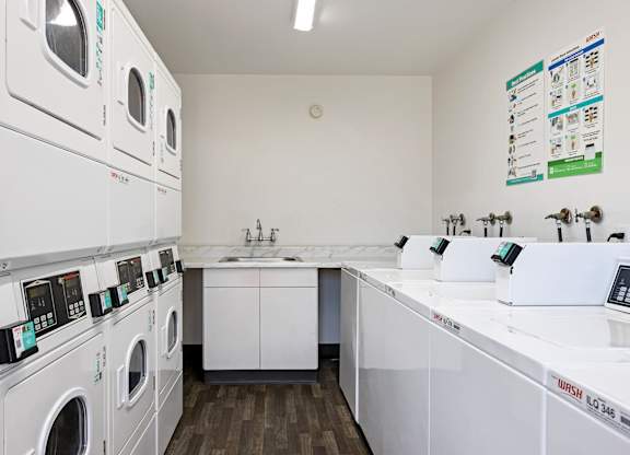 A laundromat with a row of washers and dryers.