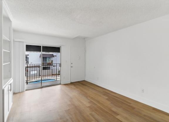 A room with wooden floors and white walls.