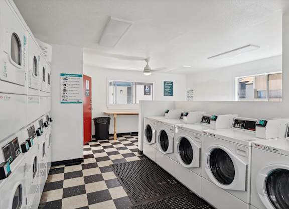 A row of washing machines in a laundromat.