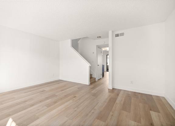 A room with wooden floors and white walls.