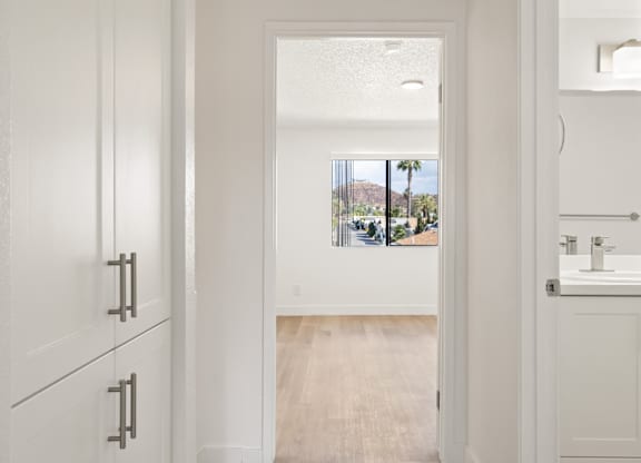 A bathroom with a white sink and cabinet.