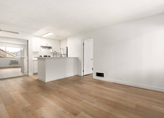A room with wooden floors and white walls.