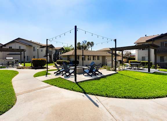 A park with a bench and a swing set.