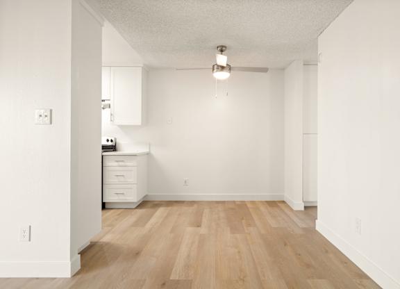 A room with wooden floors and white walls.