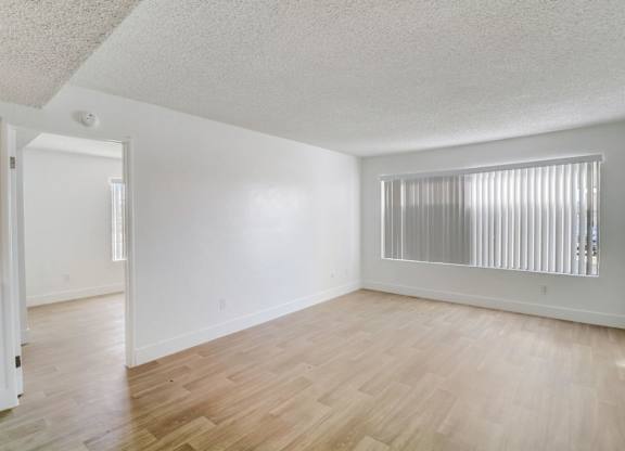 A room with wooden floors and white walls.