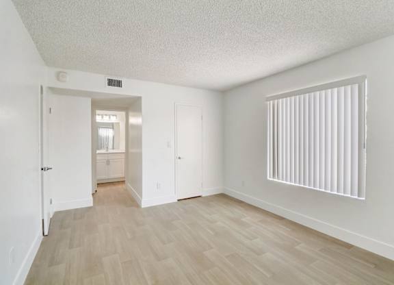 A room with a wooden floor and white walls.