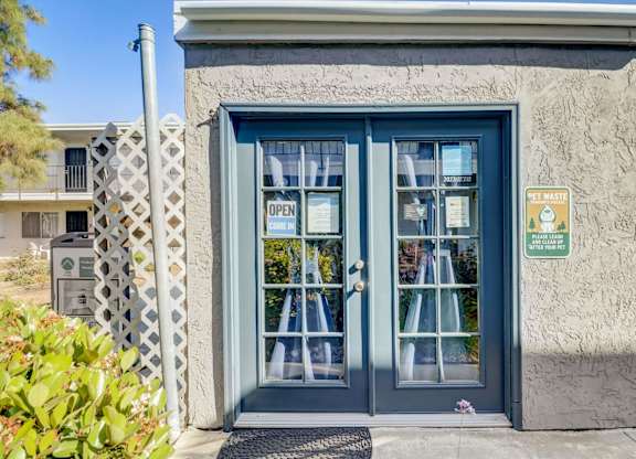 A blue door with a sign that says