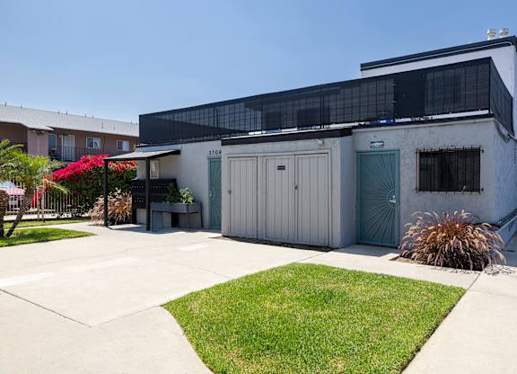 A building with a grey exterior and a black awning.
