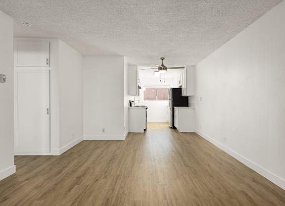 A room with wooden floors and white walls.