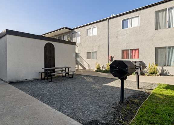 A small building with a picnic table in front of it.