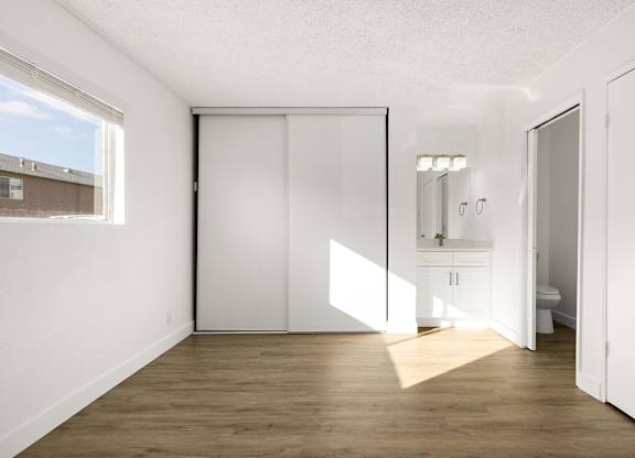 A white room with a sliding door and a window.