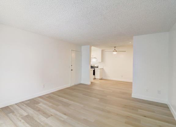 A room with wooden floors and white walls.