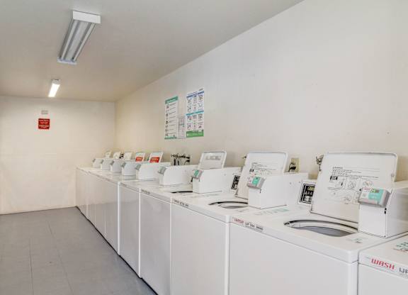 A laundromat with rows of washing machines.