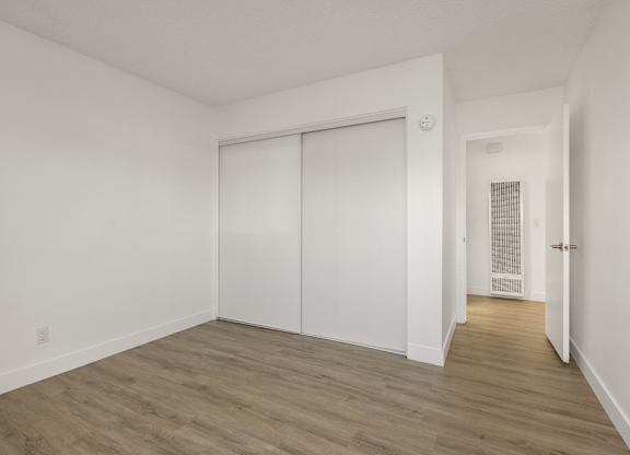 A room with a sliding door and a heater on the wall.