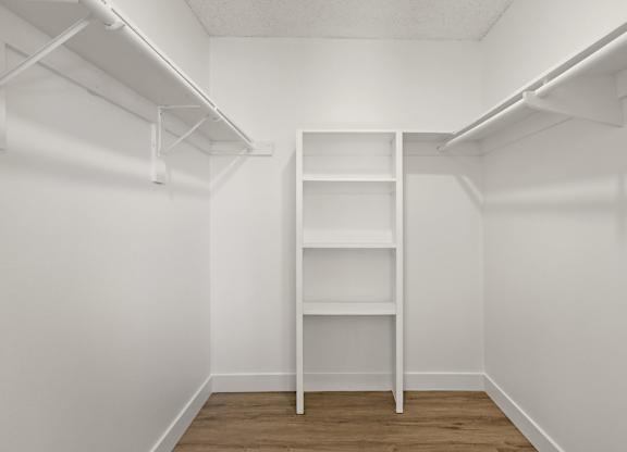 A white shelf in a white room.