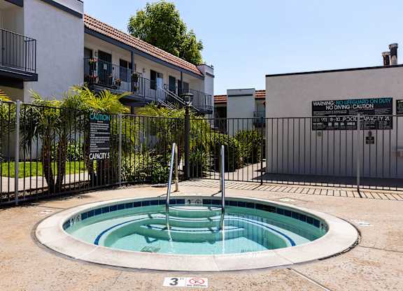 A pool with a warning sign in front of a building.