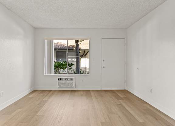 A room with a window and a door.