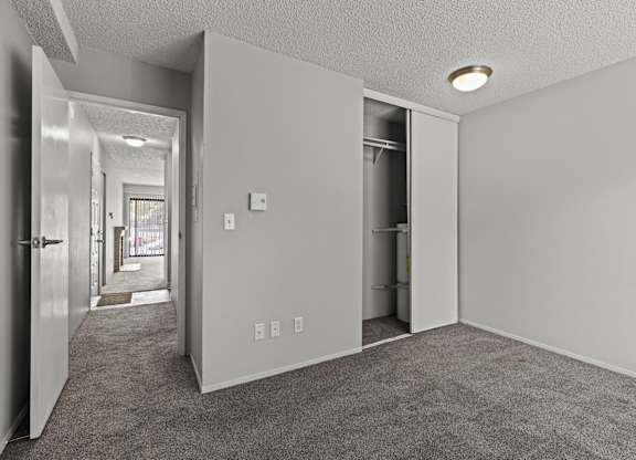 A room with a carpeted floor and white walls.