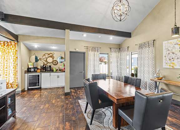 A dining room with a wooden table and chairs.