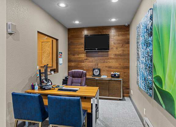 A room with a wooden wall and a television mounted on it.