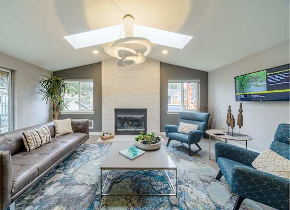 A living room with a fireplace and a TV mounted on the wall.