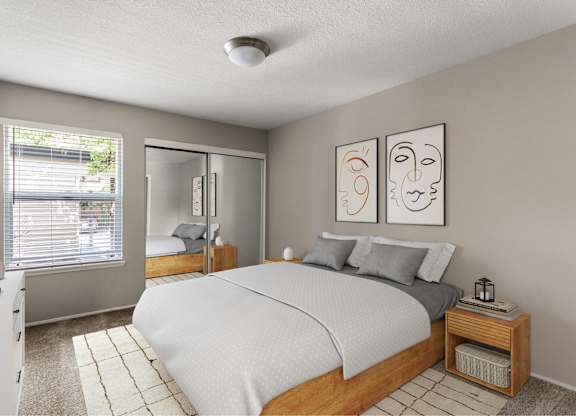 A bedroom with a bed, nightstand, and two framed pictures on the wall.