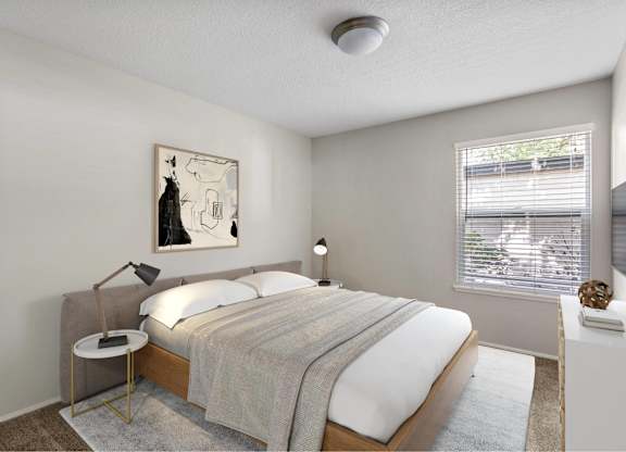 A bedroom with a bed, nightstand, and a painting on the wall.