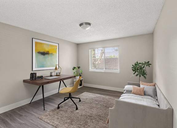 A room with a bed, desk, and chair.