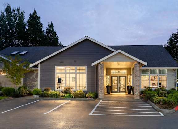 A building with a parking lot in front of it.