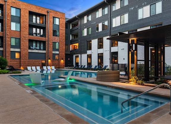 A swimming pool in front of a modern building.
