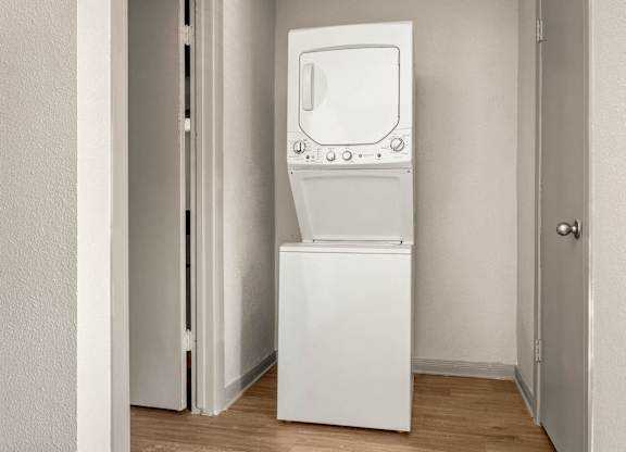 A white washing machine in a small room.