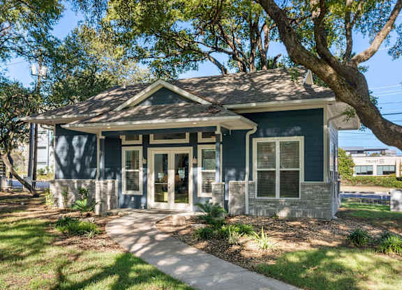 A blue house with a white door and windows.