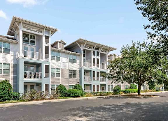 A large building with parking in front of it.
