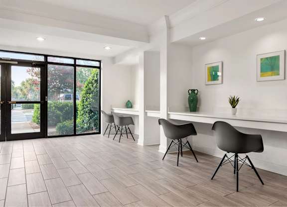 A modern living room with a table and chairs.
