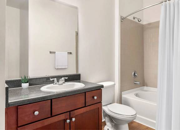 A bathroom with a bathtub and toilet.