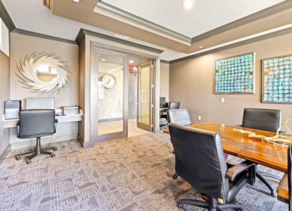 A conference room with a wooden table and chairs.