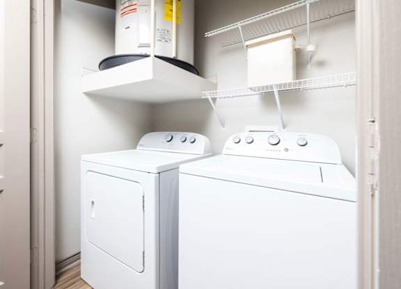 A white washing machine and dryer in a small laundry room.