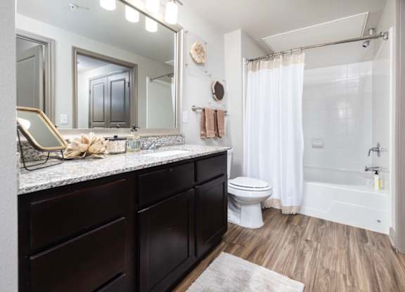 A bathroom with a white toilet and a white shower curtain.