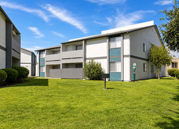 A building with a green lawn in front of it.