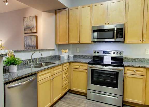 A kitchen with wooden cabinets and stainless steel appliances.