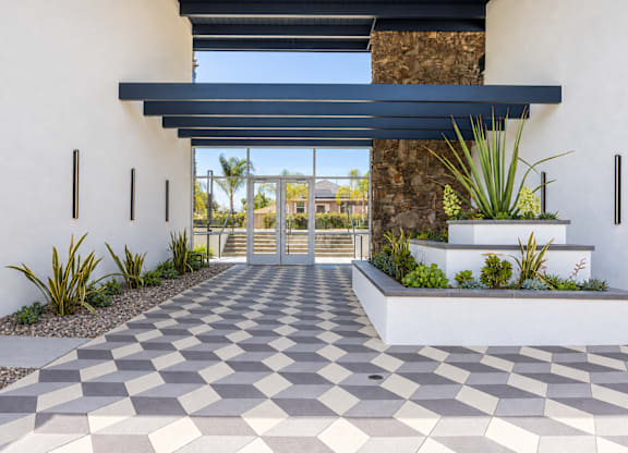 A modern house entrance with a checkered floor.