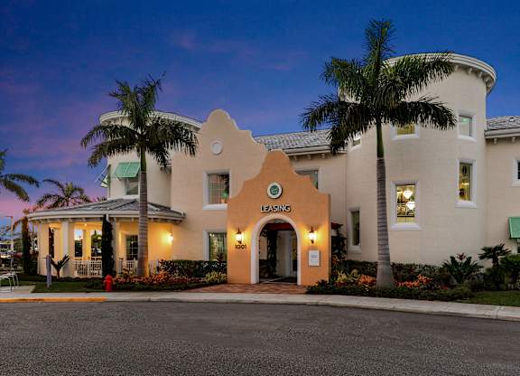 A building with a palm tree in front of it.