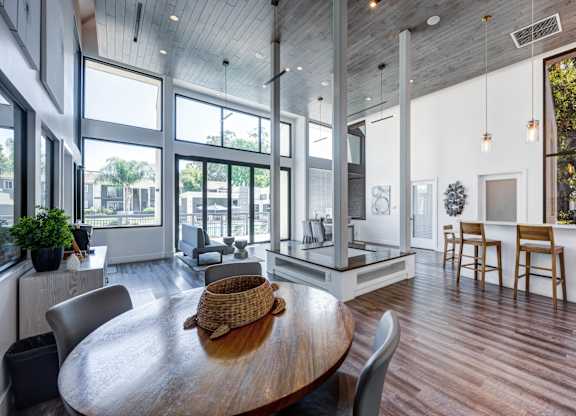 A modern dining room with a wooden table and chairs.
