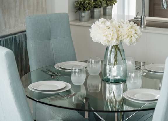 Glass dining table with white flowers at Kanata Lakes Apartments, Ontario