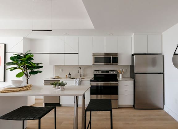Modern white kitchen with breakfast bar at 929 Richmond Apartments, Ottawa