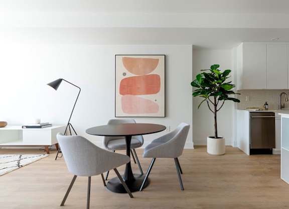 Modern dining area with round table at 929 Richmond Apartments, Ontario