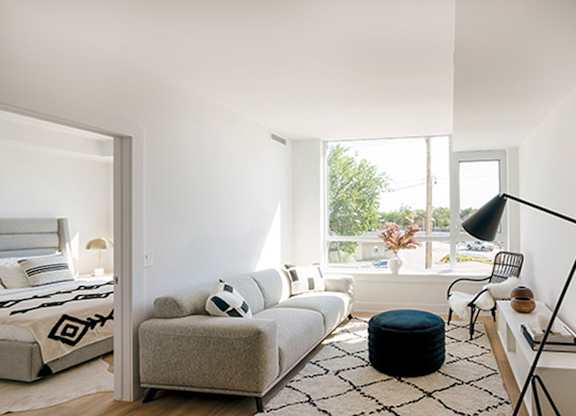 Modern living room with sectional sofa at 929 Richmond Apartments, Ontario, K2B 6R1