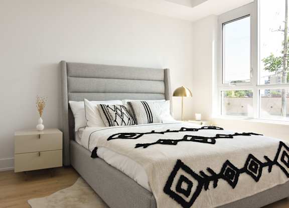 Modern bedroom with upholstered headboard at 929 Richmond Apartments, Ottawa, ON K2B 6R1
