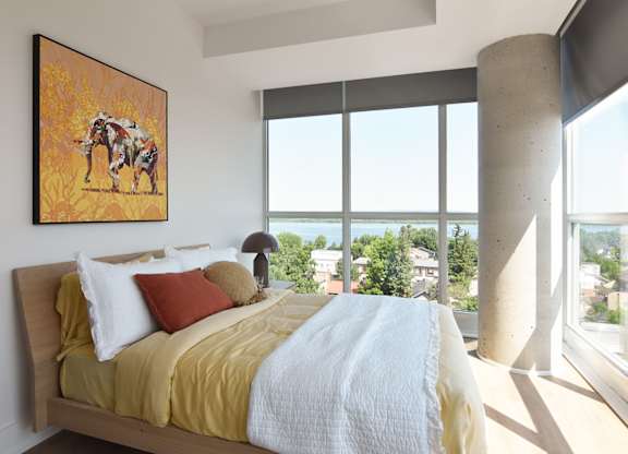 Bedroom with large windows and city views at 929 Richmond Apartments, Ottawa, Ontario